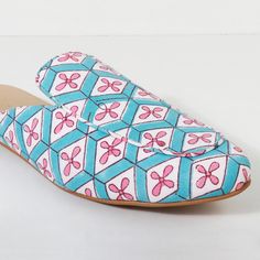 a pair of blue and pink patterned shoes