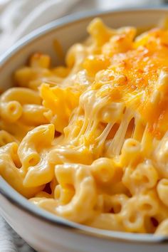 a bowl filled with macaroni and cheese on top of a table