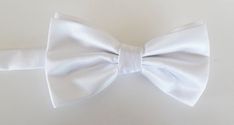 Beautiful pre-tied and adjustable double tiered banded bow tie. Will adjust from 13" through 20" neck. Bow dimensions 2.5" x 4.5". Bow tie comes complete with matching free pocket square.Always made by hand and to your special order. Weddings and groups are welcome. Adjustable White Bow Tie Back, White Adjustable Bow Tie Back, White Standard Bow Tie, Summer Bow Ties For Black Tie Events, Summer Bow Tie For Black Tie Events, Summer Bow Tie For Black-tie Events, Adjustable White Bow Tie With Decorative Bow, Summer Black Tie Bow Tie With Satin Bow, Adjustable White Bow Tie