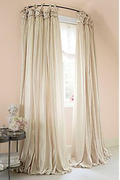 an image of a window with curtains in the middle and pink drapes hanging from it