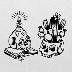 two skulls are sitting next to each other in front of a cactus and a book