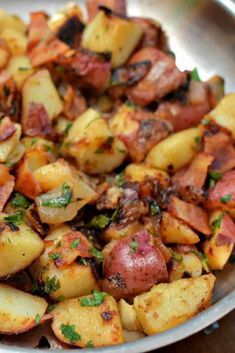 a white plate topped with potatoes and bacon