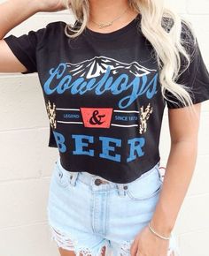 Product Details: - Material: Soft and lightweight 100% cotton - Color: Black crop top with a white and red graphic - Design: Vintage-inspired graphic with "Cowboys and Beer" phrase - Style: Crop top, perfect for pairing with high-waisted jeans or shorts - Fit: Relaxed fit with a cropped length - Size Options: Available in S, M, L, XL - Made and shipped from USA Perfect for your country concert and festivals or adding an edgy touch to your everyday look. Order yours today! Summer Concert Top With Front Print, Red Graphic Print Top For Concert, Red T-shirt For Summer Concert, Summer Concert Tops With Logo Print, Trendy Letter Print T-shirt For Concert, Crew Neck Top With Letter Print For Concerts, Hip Hop Style Summer Fan Merchandise Tops, Grunge Tops With Letter Print For Fan Merchandise, Crew Neck Tops With Text Print For Concerts