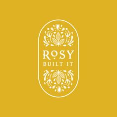 the logo for rosy built it, which is yellow and white with an ornate design