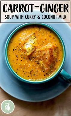 a blue bowl filled with soup on top of a wooden table