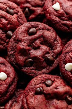 red velvet cookies with chocolate chips and white chocolate chips on the top are piled together