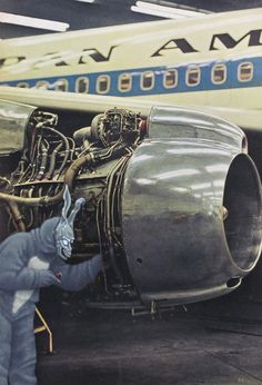 an airplane engine being worked on by a man in a bunny suit standing next to it