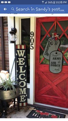 a red door with two welcome signs on it and a welcome mat in front of it