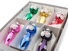 four different colored cat shaped objects in a box