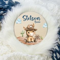 a personalized ornament for a baby's first birthday with a cowboy theme