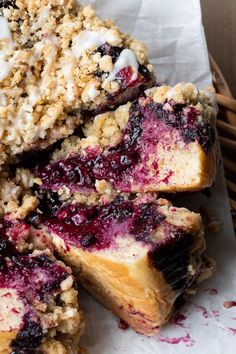 blueberry crumb bars stacked on top of each other in a wicker basket