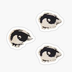 three black and white stickers with an eye on the front, one in the middle