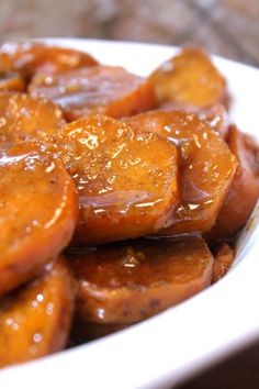 a close up view of some food on a plate with sesame seeds and sauce over it