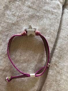 "Bracelet with stretch cord and a small (1cm) Sterling silver star which can be personalized with a name, initials or date. It is made by hand by our senior silversmith, Don Jesus, in Mexico. The length of the cord can be adjusted so it will fit any size of wrist. You can choose the color of the cord, which has the \"Confidence in Textiles\" certificate of sustainability. Both quality materials minimize allergy prone skin reactions. This bracelet is a favorite with girls - they love wearing it. Adjustable Stretch Bracelet With Star Charm As Gift, Handmade Adjustable Star-shaped Stretch Bracelet, Handmade Adjustable Star Stretch Bracelet, Handmade Adjustable Star Shaped Stretch Bracelet, Silver Adjustable Name Bracelet, Hand Stamped, Adjustable Silver Name Bracelet With Hand Stamped Details, Adjustable Star-shaped Stretch Bracelet As A Gift, Adjustable Star-shaped Stretch Bracelet Gift, Silver Star Bracelet For Friendship