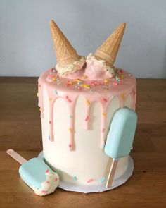 a cake with ice cream and sprinkles on it, sitting on a table