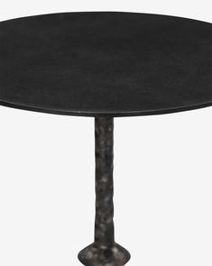 a round black table with a metal base and an iron column at the bottom, on a white background