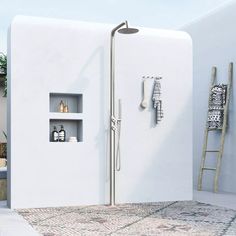 a bathroom with a shower and shelves on the wall