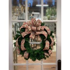 a christmas wreath on a window sill