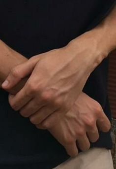 a close up of a person holding their hands together