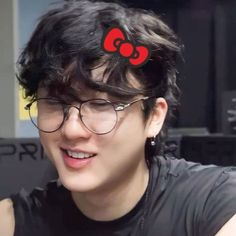 a person with glasses and a bow in their hair