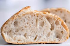 two pieces of bread sitting on top of a white countertop next to each other