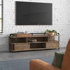 a living room with a couch and television on the wall