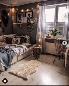 a bed room with a neatly made bed next to a window and a desk in front of it