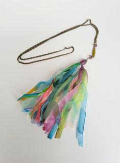 Colorful silk necklace with small hand-painted ribbons linked together and mounted on a fancy bronze-colored metal chain Total length 54 cm Length for 19 cm Width 5 cm Packaging : carefully packaged in an organza bag and tissue paper Possibility of having a free gift box to offer - Report it by message Sent in a bubble envelope - business card Sending : by letter followed for France Multicolor Tassel Necklace As Gift, Multicolor Tassel Necklace For Gift, Multicolor Long Tassel Necklace Gift, Elegant Multicolor Hand-strung Necklace, Silk Ribbon Necklace, Silk Necklace, Elegant Hand-dyed Multicolor Silk Scarf, Ribbon Necklace, Boho Fall