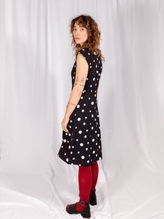 Go mod in this bold fit and flare dress. Its punchy polka dots, accented with contrasting hand embroidery, make a playful print that could be paired with bright tennis shoes for a fun everyday look or some tights and heels to fancy it up a bit. Fit Note: True to size. Fitted style. Those in between sizes may wish to size up. 100% cotton Hand screen printed. Hand embroidery Zips at back. Length of size M is 40.5" from top of bodice Made fair trade in India by one of our longstanding production pa French Knot Embroidery, Tights And Heels, Fair Trade Clothing, Screen Printed Fabric, Red Maxi, Red Dress Maxi, Fitted Style, Polka Dress, Oversized Style