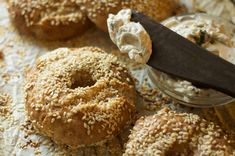 bagels with cream cheese and sesame sprinkled on them