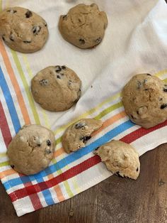 six chocolate chip cookies sitting on top of a towel