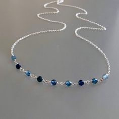 Genuine, premium-quality, shaded Kanchanaburi blue sapphire beaded choker/necklace, wire-wrapped in sterling silver This dainty and elegant choker/necklace is designed with genuine, 3.5 mm, micro-faceted ombré Kanchanaburi blue sapphire gemstones wire-wrapped to form a chain of linked gemstones as the frontal segment, measuring 2.5 inches and linked to a dainty but sturdy sterling silver chain. These gemstones are finely-faceted, highly polished and; while tiny, reflect light beautifully.  This Saphire Jewelry, Sapphire Choker, Blue Gemstone Necklace, Elegant Choker, Tiny Pendant, Blue Sapphire Gemstone, Beaded Choker Necklace, Necklace Blue, Sapphire Necklace