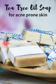 several soap bars on a plate with blue and white ribbons