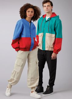 two people standing next to each other wearing jackets and sweatpants, both with hoods on