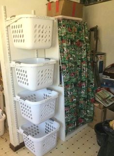 three white laundry baskets stacked on top of each other