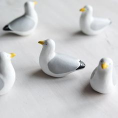 small white birds sitting on top of a table