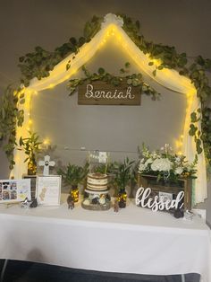 a table topped with a cake covered in greenery