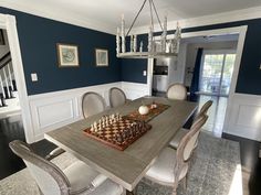 a dining room table with chess set up on it