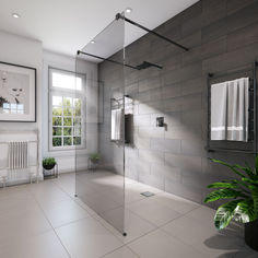 a bathroom with a shower, toilet and window