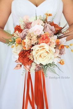 a bridal bouquet with orange and pink flowers