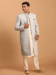 Vastramay Men's Grey Jaccard Sherwani With Cream Kurta Pant Set Make a style statement with this elegant grey jacquard sherwani paired with a cream kurta and pant set. Perfect for weddings and festive occasions, this outfit is crafted with attention to detail and fine craftsmanship. Features: Elegant grey jacquard fabric Cream kurta with intricate design Comes with matching pant Perfect for weddings and festive occasions Specifications: Brand: VASTRAMAY Color: Grey and Cream Material: Jacquard Size: Available in various sizes Material & Care: Jacquard fabric, Dry clean only Legal Disclaimer: The product is guaranteed to be 100% genuine. Product images are for illustrative purposes only. Images/packaging/ labels may vary from time to time due to changes made by the manufacturer's manufactur Classic Sherwani For Groom, Festive Occasion, Classic Sherwani For Groom In Festive Season, Classic Festive Sherwani For Groom, Elegant Silver Kurta For Formal Occasions, Traditional Gray Kurta For Wedding, Gray Fitted Kurta For Eid, Fitted Gray Kurta For Eid, Fitted Gray Sets For Eid, Gray Kurta For Wedding And Eid