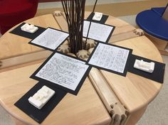 four pieces of paper sitting on top of a wooden table with writing on the sides