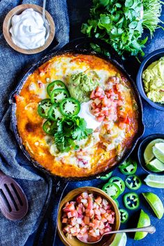 mexican food with guacamole, salsa and limes on the table top