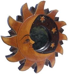 a wooden sun and moon decoration hanging on a wall with stars around the clock face