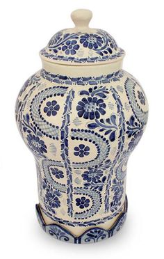 a blue and white vase with a lid