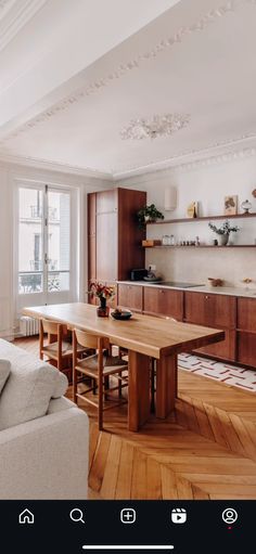 a large wooden table sitting in the middle of a living room