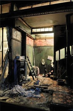 an abandoned building with broken windows and debris on the floor