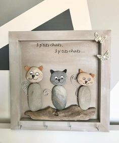 three cats sitting on top of a rock in a shadow box with the words 3 pitts chat, p'tis chat