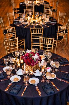 an image of a table set up for a formal event with candles and flowers on it