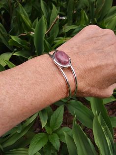 |  PRODUCT INFO  |                        This simple yet bold silver plated cuff bracelet features a pretty pink Rhodonite cabochon ( 18 x 13 mm. ).  Fits an average size wrist .  Adjustable.